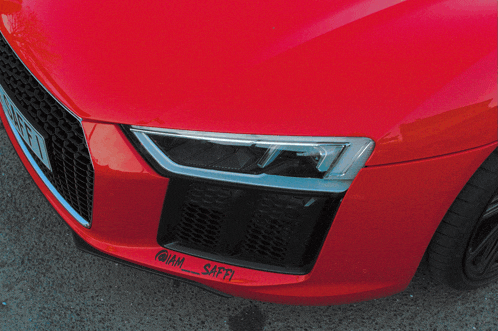 a red car with a sticker on the front that says iam_safii