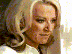a close up of a woman 's face with blonde hair and a white shirt on .