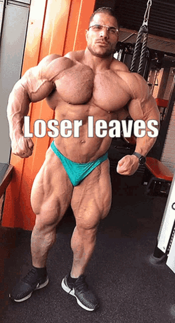 a bodybuilder with the words loser leaves written on his chest
