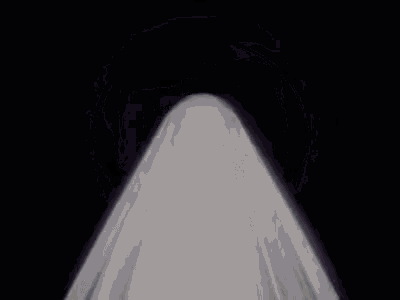 a close up of a white object in a dark room .