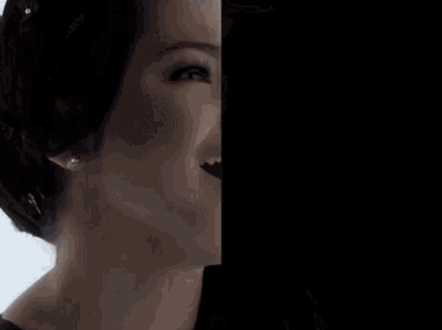 a close up of a woman 's face with her mouth open and a crown on her head .