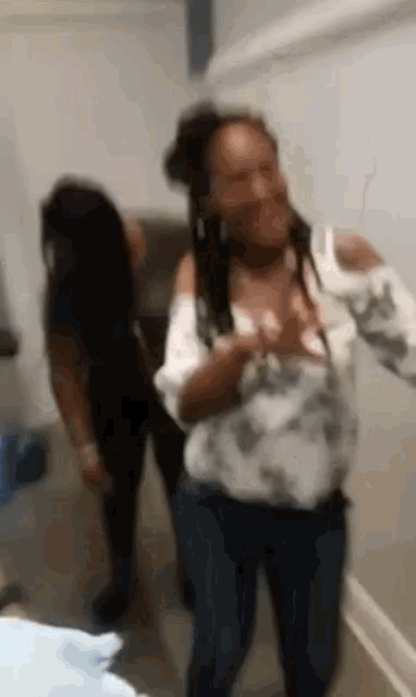 a blurry picture of two women dancing in a room .