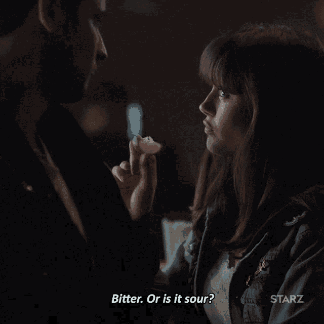 a man talking to a woman with starz written on the bottom right