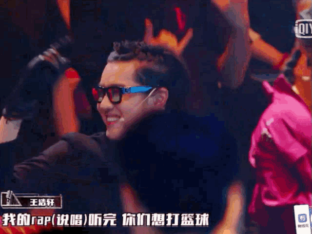 a group of people are gathered in a dark room with chinese writing on the walls