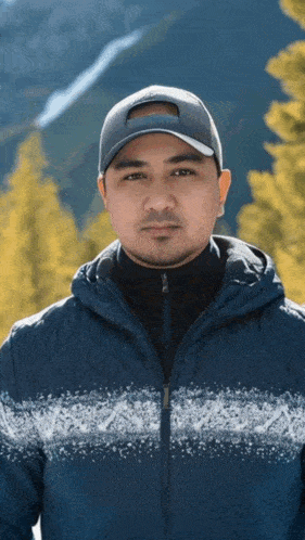 a man wearing a baseball cap and a blue jacket