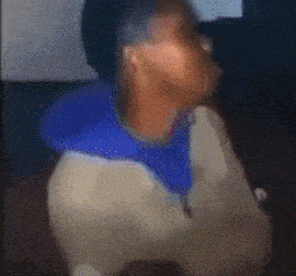 a blurry picture of a person with a blue hoodie on