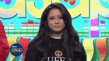 a girl wearing a black shirt that says life