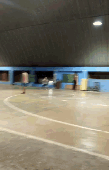 a blurry picture of a basketball court with a white line on the floor