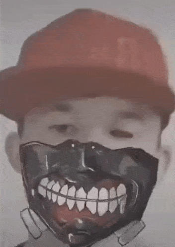a man wearing a red hat and a black mask with teeth