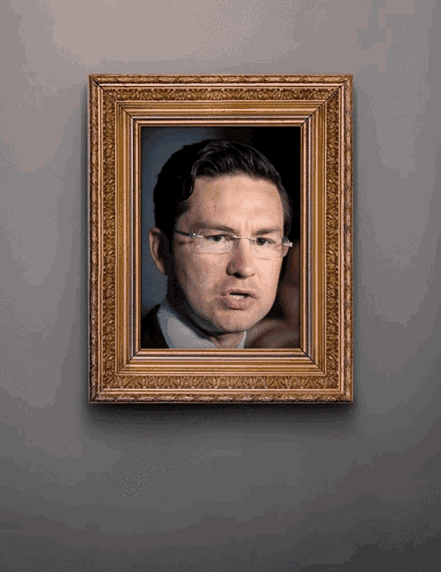 a framed picture of a man with glasses on