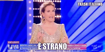 a woman in a gold dress stands in front of a blue background with trash italiano written on it