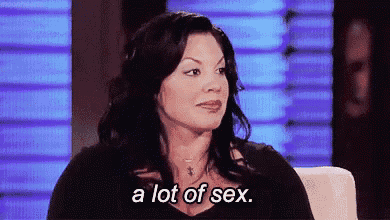 a woman is sitting in a chair talking about sex .