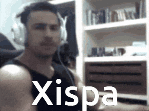 a man wearing headphones is standing in front of a shelf with the word xispa on it