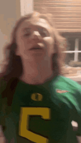 a man wearing a green jersey with the number 5 on it