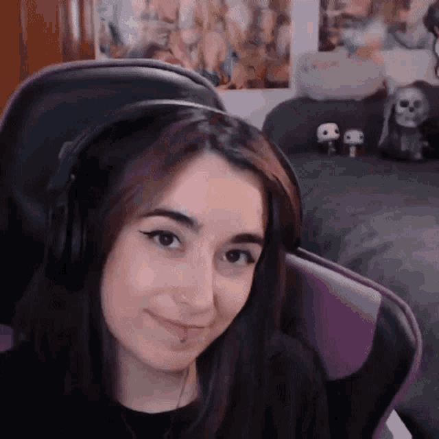 a woman is wearing headphones and sitting in a chair