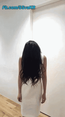 a woman in a white dress is standing in front of a white wall with the url fb.com/ssvakr