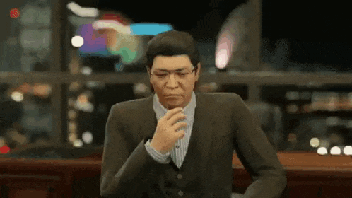 a man in a suit and tie is sitting at a table in a video game .
