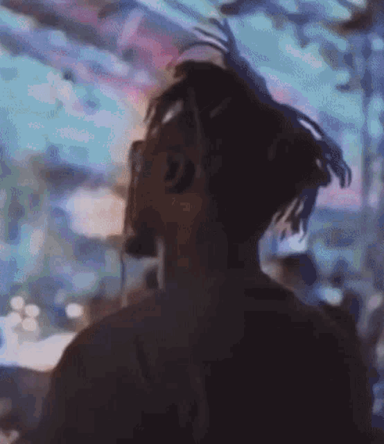 a blurry picture of a man wearing headphones in a dark room