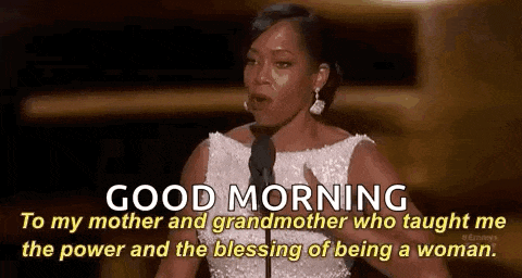 a woman in a white dress is giving a speech at an awards ceremony .