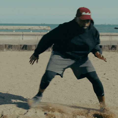 a man wearing a black sweatshirt and a red hat with the word sd on it