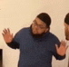 a blurry picture of a man in a blue sweater standing next to another man .