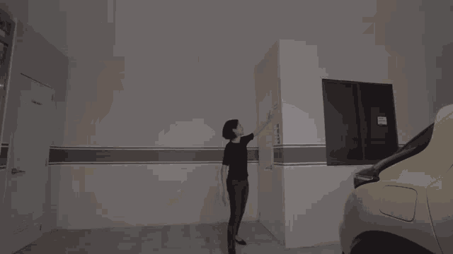 a woman walking down a set of stairs in front of a door labeled smoking room