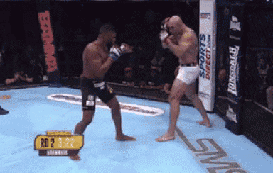 two men are boxing in a ring with a sign that says rd2 1-22