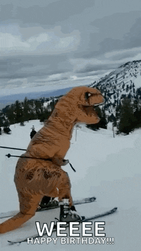 a person in a t-rex costume is skiing down a snowy mountain .