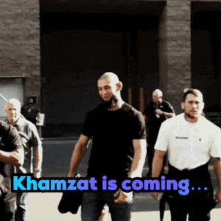 a group of men walking down a street with khamzat is coming written on the bottom