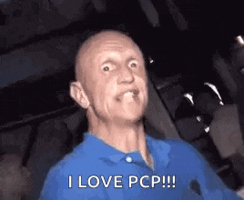a bald man in a blue shirt is making a funny face and saying `` i love pcp !!! ''