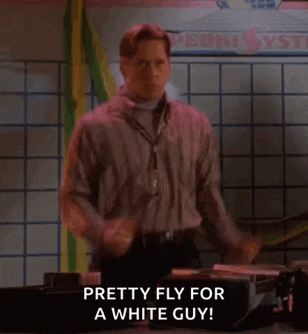a man in a striped shirt is dancing in front of a sign that says pretty fly for a white guy .