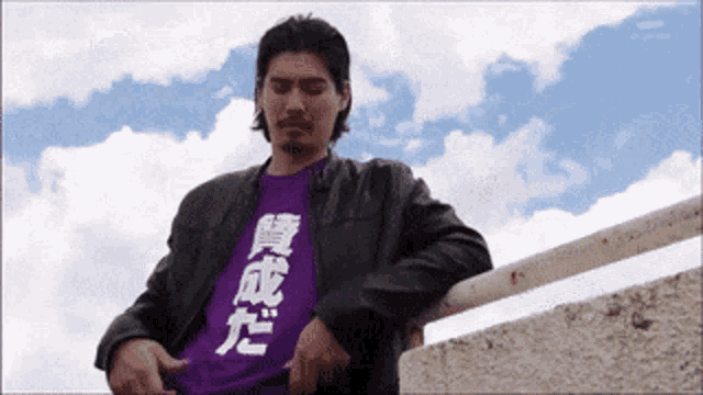 a man wearing a purple t-shirt with chinese writing on it