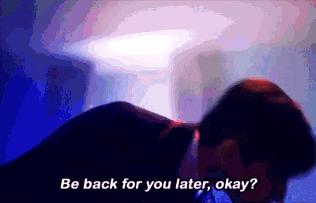 a man is laying down in a dark room with the words `` be back for you later , okay '' written on the bottom .