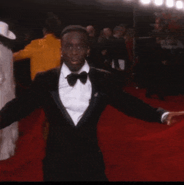 a man is doing a handstand on the red carpet