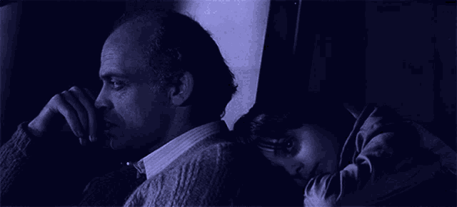 a man and a girl are sitting next to each other
