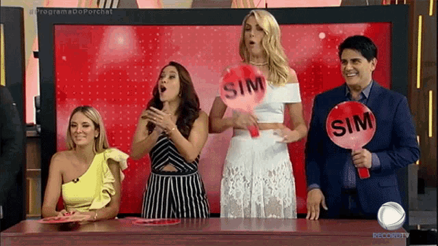 a group of people are holding up signs that say sim