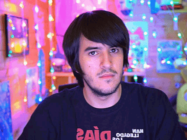 a man wearing a black shirt that says ' haid ' on it