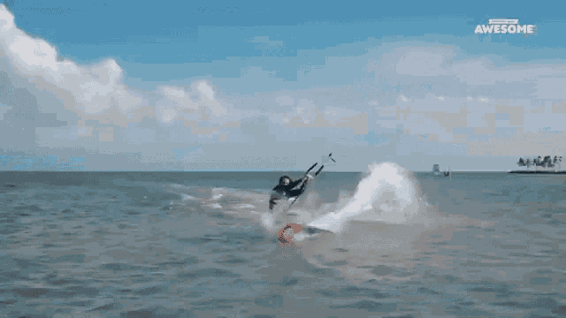 a man is flying through the air while riding a surfboard with the words " awesome " above him