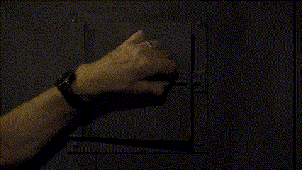 a man in a prison cell behind a fence