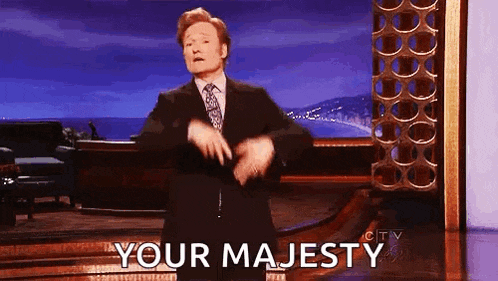 a man in a suit and tie is dancing on a stage with the words `` your majesty '' written on the bottom .