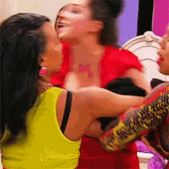a woman in a yellow tank top is kissing another woman