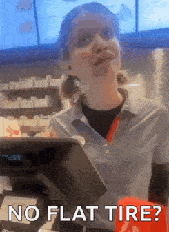 a woman behind a counter with the words no flat tire below her