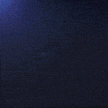 a dark blue background with a few white spots
