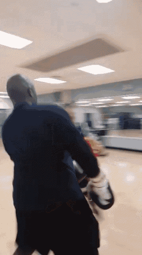 a blurry photo of a man wearing boxing gloves in a gym