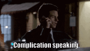 a man in a suit and tie is talking on a cell phone with the words complication speaking written below him .