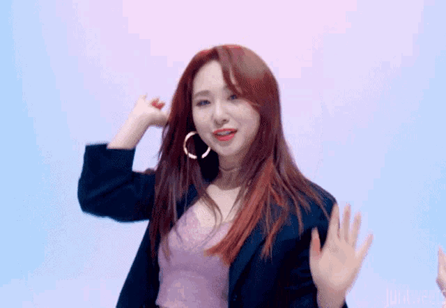 a woman with red hair is wearing a choker and a jacket