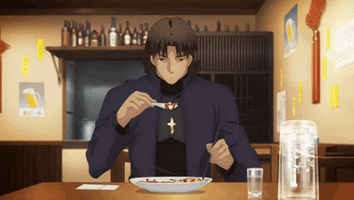 a man is sitting at a table with a plate of food on it