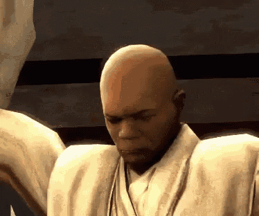 a bald man in a white shirt is looking down at something