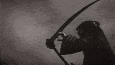 a black and white photo of a grim reaper holding a scythe in his hand .