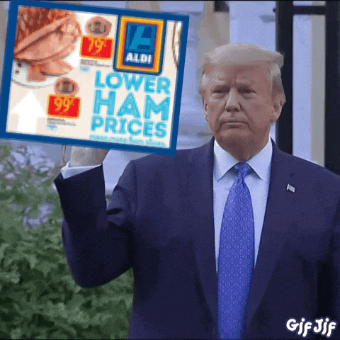 a man in a suit and tie is holding a sign that says lower ham prices
